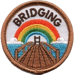 A wooden bridge stretches toward a rainbow beneath the word Bridging.