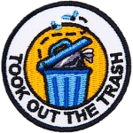A blue garbage can with a black trash bag sitting inside it. The words Took Out The Trash surround it.