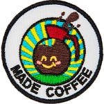 A coffee pot with a smiling face above the words Made Coffee.