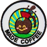 A coffee pot with a smiling face above the words Made Coffee.