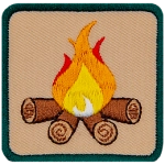 This square badge is part one of a three-part collection that displays a growing campfire. A medium yellow-orange flame burns on top of logs in this green-bordered patch.