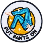 The legs of a figure pulling on a pair of jeans. The words Put Pants On are underneath.