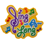 The words Sing A Long with music bars and notes in the background. The S in Sing is a backwards treble-clef.
