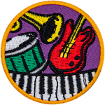 A guitar, piano, drum and trumpet on a circle patch.