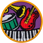 A guitar, piano, drum and trumpet on a circle patch.