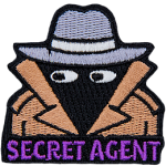 A person wearing a wide-brimmed hat and a brown trenchcoat. The words Secret Agent are across the bottom.