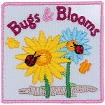 A yellow and blue flower has a ladybug on them. The words Bugs & Blooms are across the top. Two yellow butterflies are to the side.