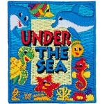 The words Under The Sea are surrounded by smiling sea creatures such as a turtle, a seahorse, two dolphins, a fish and a starfish on an ocean background.