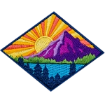 This diamond-shaped badge depicts a sun rising behind a mountain. The sun casts its rays over a lake surrounded by a forest.