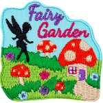 The words Fairy Garden above a lawn with mushroom houses and the silhouette of a fairy creature.