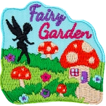 The words Fairy Garden above a lawn with mushroom houses and the silhouette of a fairy creature.