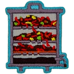 A layered vermicomposter with worms and compost inside of it.