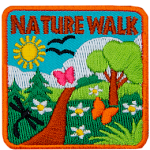 The words Nature Walk are above a green trail on a sunny day.