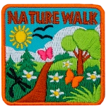 The words Nature Walk are above a green trail on a sunny day.