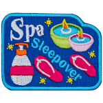 The words Spa Sleepover are between sandals, candles and lotion.