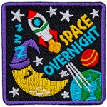 A rocket ship blasts off from the Earth next to a sleeping moon. The words Space Overnight are below the rocket.