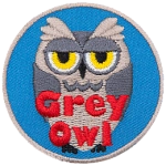 A grey owl with a sarcastic expression. The words Grey Owl are at the bottom.