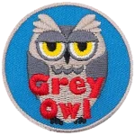 A grey owl with a sarcastic expression. The words Grey Owl are at the bottom.