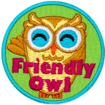 This cheerful owl waves its left wing in welcome. The words Friendly Owl are embroidered in pink lettering at the bottom of this round patch.