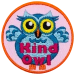 A light blue owl with big yellow eyes stands upright with its wings spread wide in welcome. The words Kind Owl are written in pink near the bottom of the patch.