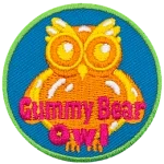 A yellow owl-shaped gummy with the words Gummy Bear Owl across the bottom.