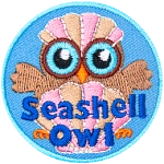 An owl sits behind a beautiful clamshell with its wings outstretched to either side. The owl wears another clam shell like a hat.
