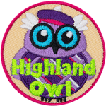 This wide-eyed bird is dressed in a checkered kilt and purple balmoral. The words Highland Owl are embroidered in green stitching.