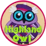 This wide-eyed bird is dressed in a checkered kilt and purple balmoral. The words Highland Owl are embroidered in green stitching.