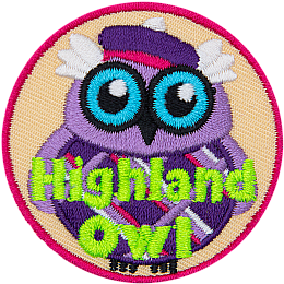 This wide-eyed bird is dressed in a checkered kilt and purple balmoral. The words Highland Owl are embroidered in green stitching.