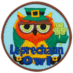 A green owl with a red beard holds a three-leafed clover. The words Leprechaun Owl are across the bottom.