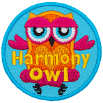 An orange and pink owl sits cross-legged. The words Harmony Owl are across the bottom.