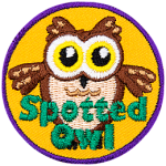 A fluffy brown owl with yellow eyes and the words Spotted Owl at the bottom.