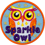 An orange, yellow and white owl with eyelashes and the words Sparkle Owl at the bottom.