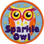 An orange, yellow and white owl with eyelashes and the words Sparkle Owl at the bottom.