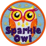 An orange, yellow and white owl with eyelashes and the words Sparkle Owl at the bottom.