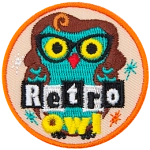 A green owl wearing a brown wig and glasses. The words Retro Owl are across the bottom.