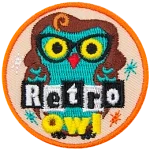 A green owl wearing a brown wig and glasses. The words Retro Owl are across the bottom.