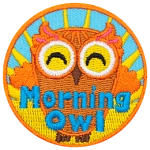 This happy owl has its arms reaching up to embrace the sunlight from the rising sun behind it. Near the bottom of the patch is the text 'Morning Owl.'