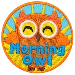 This happy owl has its arms reaching up to embrace the sunlight from the rising sun behind it. Near the bottom of the patch is the text 'Morning Owl.'