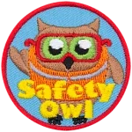 An owl wears an orange safety vest and safety glasses. The text Safety Owl is at the bottom.