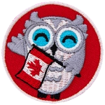 A grey and white owl holds a Canadian Flag and waves at the viewer. The background of this round patch is a bright red.