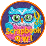 This circular patch shows a bespectacled owl holding scissors in one wing and a scrapbook in the other. The words Scrapbook Owl are at the bottom.