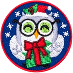 A grey owl holds a green present wrapped in a red ribbon. The owl has a Santa hat and round glasses.