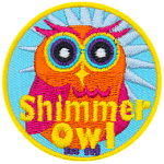 An orange and pink owl with a blue star behind it. The words Shimmer Owl are across its stomach.