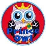 This regal prince owl wears a golden crown and a red sash pinned with a sun-shaped medal. The words Prince Owl are across the bottom.