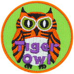 This fierce-looking owl is orange and black striped, like a tiger. The words Tiger Owl are embroidered near the bottom of this round crest.