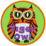 This fierce-looking owl is orange and black striped, like a tiger. The words Tiger Owl are embroidered near the bottom of this round crest.