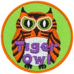 This fierce-looking owl is orange and black striped, like a tiger. The words Tiger Owl are embroidered near the bottom of this round crest.