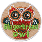 A gingerbread cookie made to look like an owl and decorated in red, white and green frosting. The words Gingerbread Owl are across the bottom.