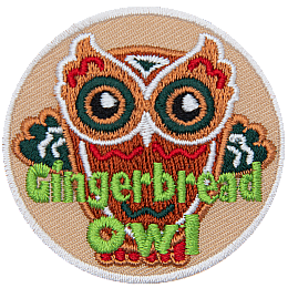 A gingerbread cookie made to look like an owl and decorated in red, white and green frosting. The words Gingerbread Owl are across the bottom.